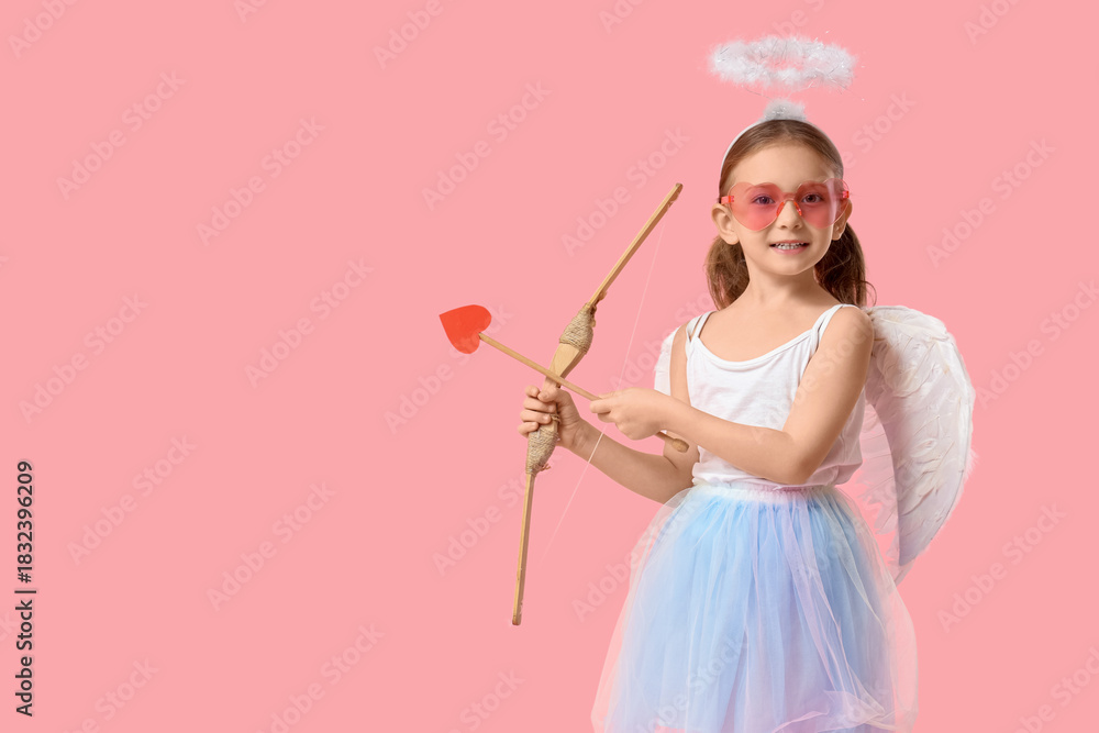 Obraz premium Cute little girl dressed as Cupid with arrow and bow on pink background. Valentine's Day celebration