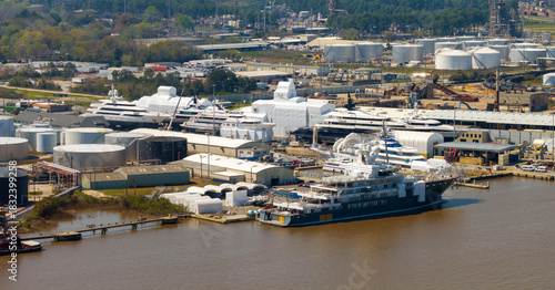 Photography Large luxury yacht under construction in shipyard with cranes