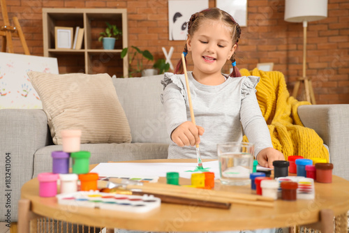 Little girl painting with b...