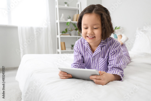 Little Asian girl watching ...