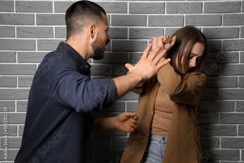 Young man beating his wife ...