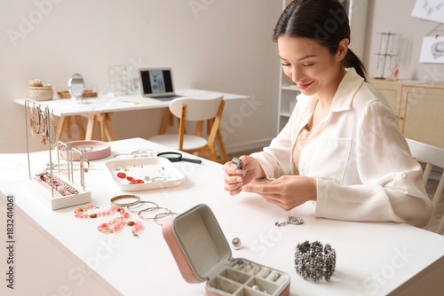 Female jewelry designer exa...