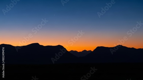 Mountain Silhouettes at Dusk with an Evening Star
