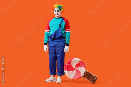 Young man dressed as sad cl...