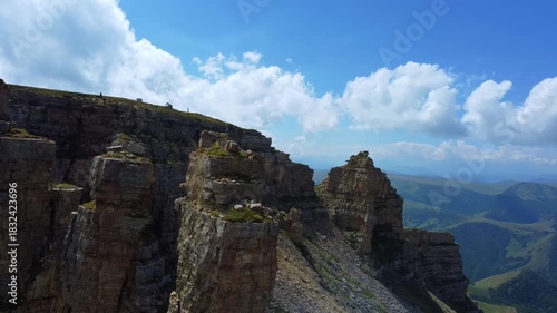 Rocks of two monks, Bermamyt plateau, Karachay-Cherkess Republic. The top of the cliff. Incredible natural epic landscape of the Caucasus, Elbrus region. 4K. dron