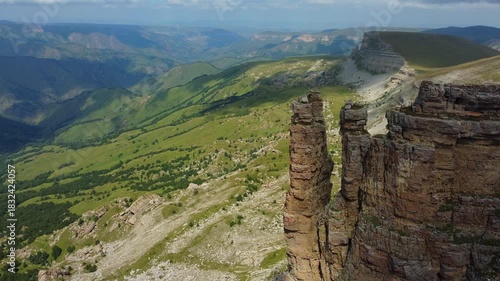 Rocks of two monks, Bermamyt plateau, Karachay-Cherkess Republic. The top of the cliff. Incredible natural epic landscape of the Caucasus, Elbrus region. 4K. dron
