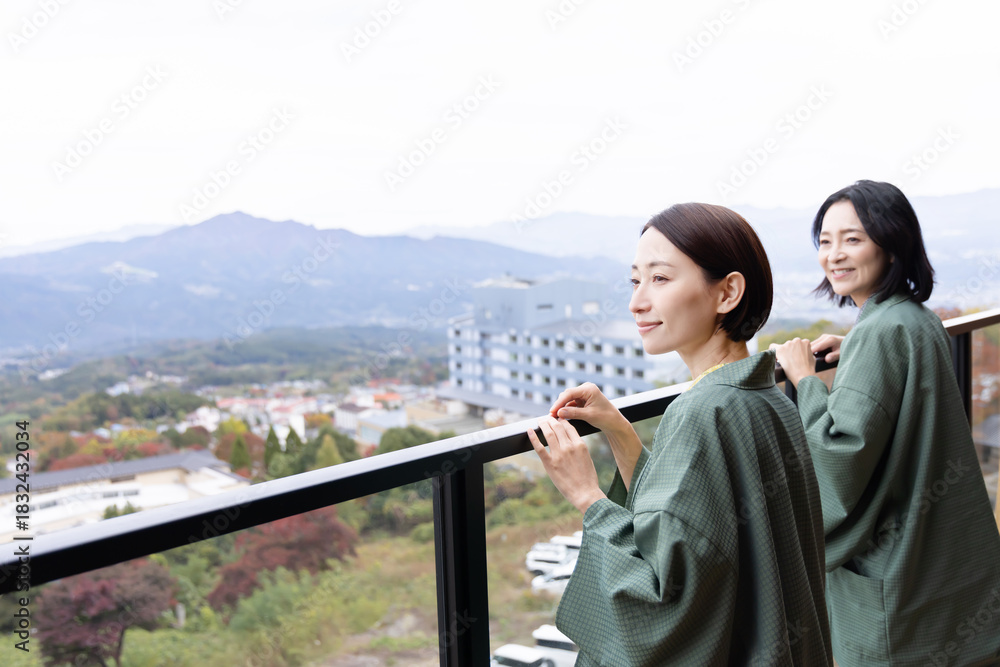 Naklejka premium 女子旅 温泉旅館 屋外の景色を眺める女性