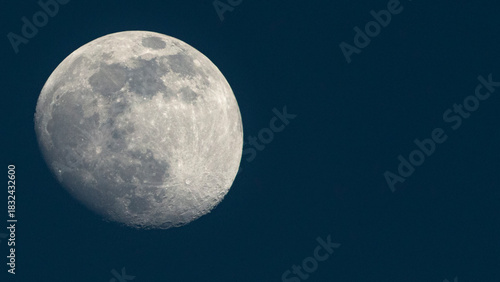 The full moon in the dark blue sky. Close-up.