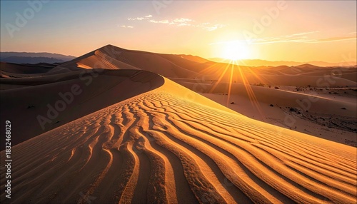 Fototapeta Naklejka Na Ścianę i Meble -  Scenic view of sand dunes in a desert landscape at sunset, with golden light and shadows.