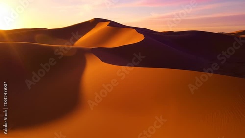 Cinematic wide shot of golden hour sunlight slowly moving and illuminating the smooth abstract surface of warm desert sand calm, nature, meditation