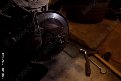 Classic car wheel bearing replacement. Comprehensive used car repair. Garage service for restoring old cars. Car warranty service concept. Suspension component replacement.