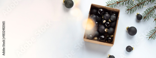 Minimalist Christmas Flatlay with Black Baubles and Gift Box