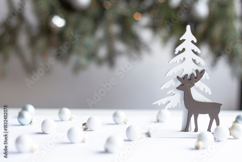 Minimalist Winter Scene with Wooden Reindeer and Christmas Baubles