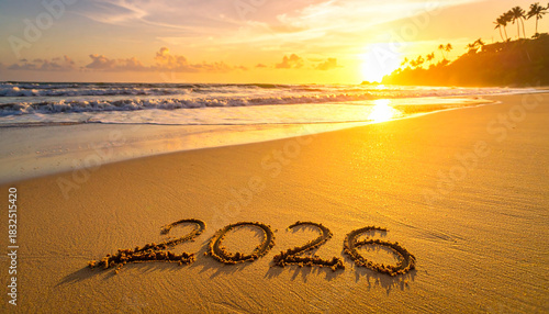 Fototapeta Naklejka Na Ścianę i Meble -  2026 written in sand on a tropical beach during a golden sunset with palm trees  2026, sand, beach, sunset