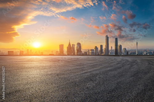 Empty asphalt road and city skyline with modern buildings at sunrise in Guangzhou