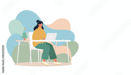 Remote worker using laptop at a festive winter desk with Christmas decorations
