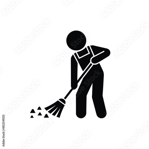 Silhouette of a person in overalls sweeping dirt with a broom