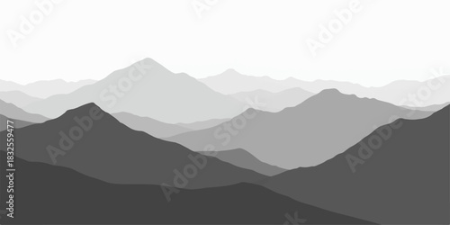 Mountain landscape view with peaks and misty blue morning sky