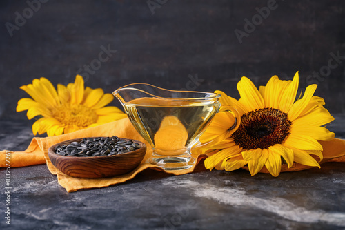 Jug of sunflower oil, flowe...