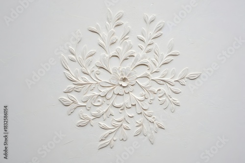 White Floral Relief Sculpture on Textured Background