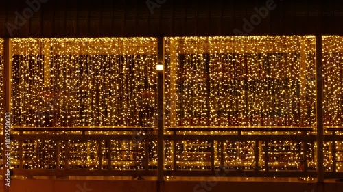 Timelapse Modern Bridge Walkway with Golden String Lights: Urban Architecture Night View with Festive Illumination and Glass Railing