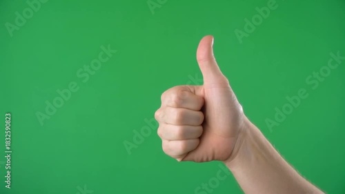 Wallpaper Mural Hand gesturing thumbs up against green background Torontodigital.ca
