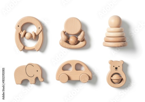 Collection of wooden baby toys, including a bear, elephant, car, and stacking rings, displayed on white.