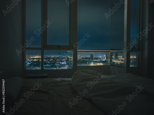 Experience a Captivating Night Cityscape View from the Comfort of Your Cozy Bedroom Space