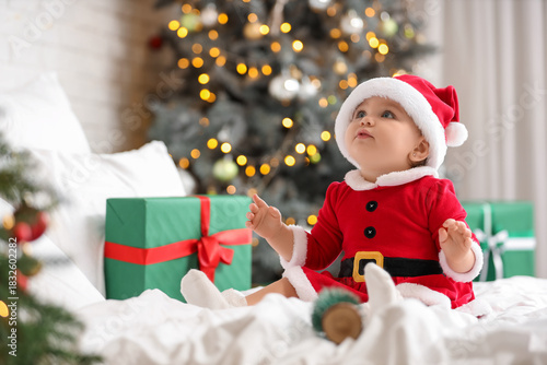 Cute little baby in Santa c...