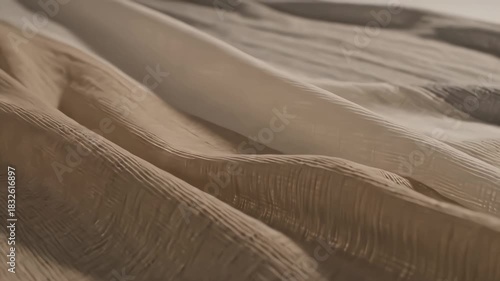 Smooth flowing fabric folds moving gently like soft cloth in the wind, creating elegant organic motion with subtle highlights