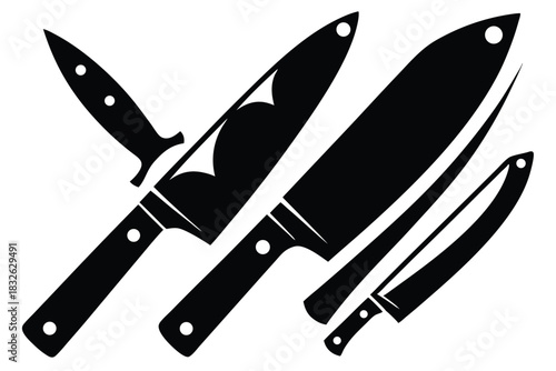 Several black kitchen knives of varied shapes and sizes are arranged together on a white backdrop