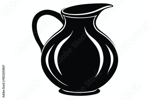 A sleek black pitcher with a handle and spout stands prominently on white