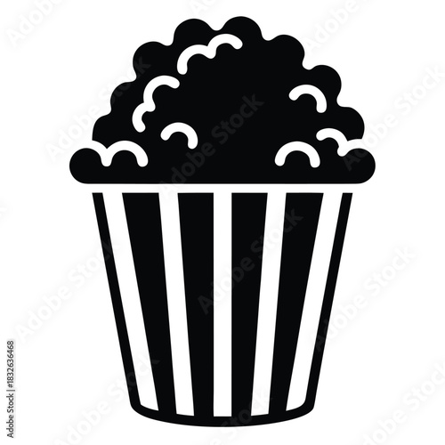 A full black and white striped popcorn bucket offers a classic cinema snack