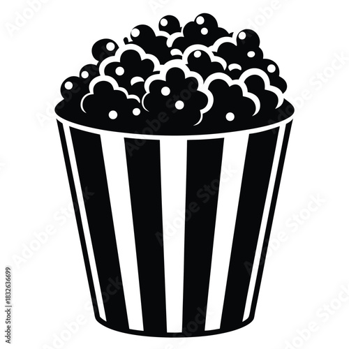 Black and white popcorn overflowing in striped container presents classic simple food icon