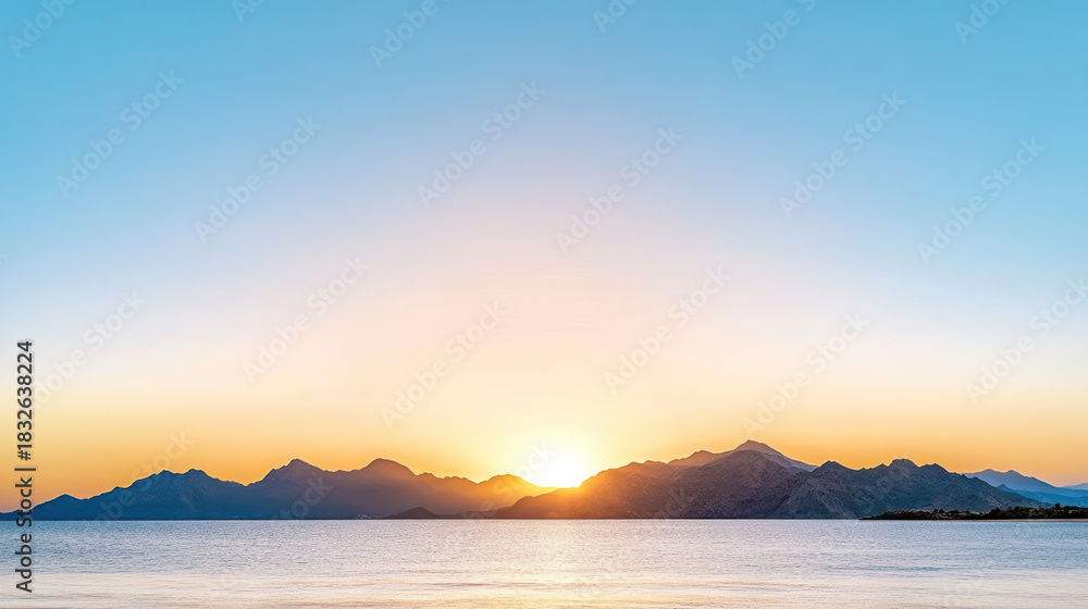 Fototapeta premium Soft pastel sunrise over mountain silhouette and calm sea, peaceful light