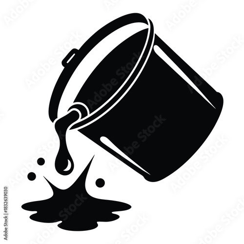 An overturned bucket spills black paint, causing a small splatter on the surface