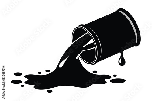 Overturned black bucket spills liquid, creating a splatter on a white surface creating striking contrast