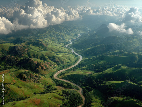 Aerial View of Lush Green Hills and Winding River Valley with Dramatic Clouds, Serene Landscape, Natural Beauty, and Scenic Vista