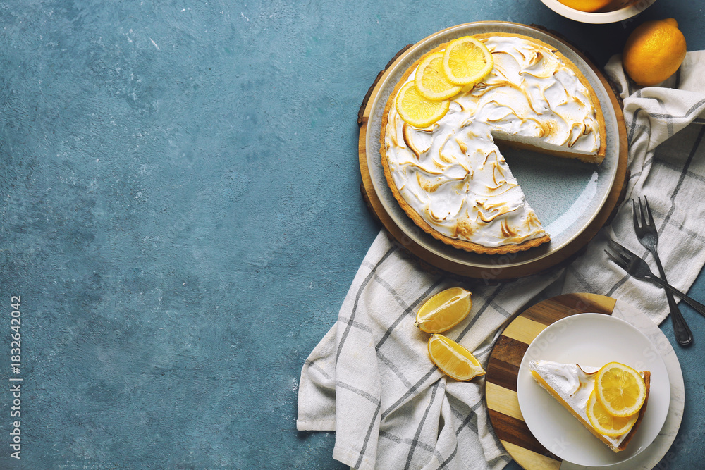 Obraz premium Plate with tasty lemon pie and ingredients on blue grunge background