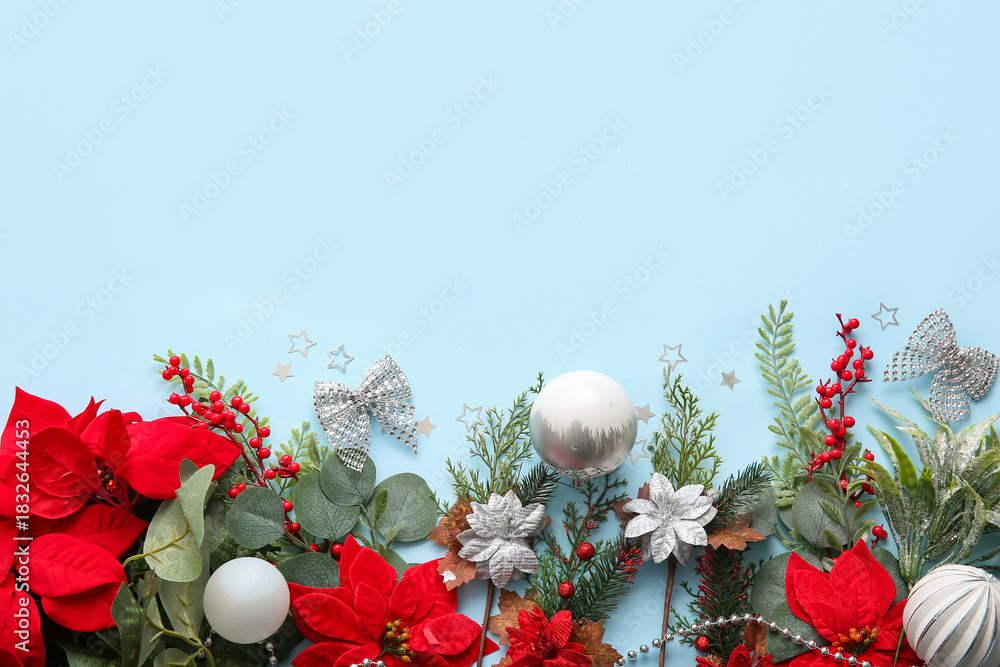Obraz premium Composition with Christmas poinsettia flowers and decorations on blue background