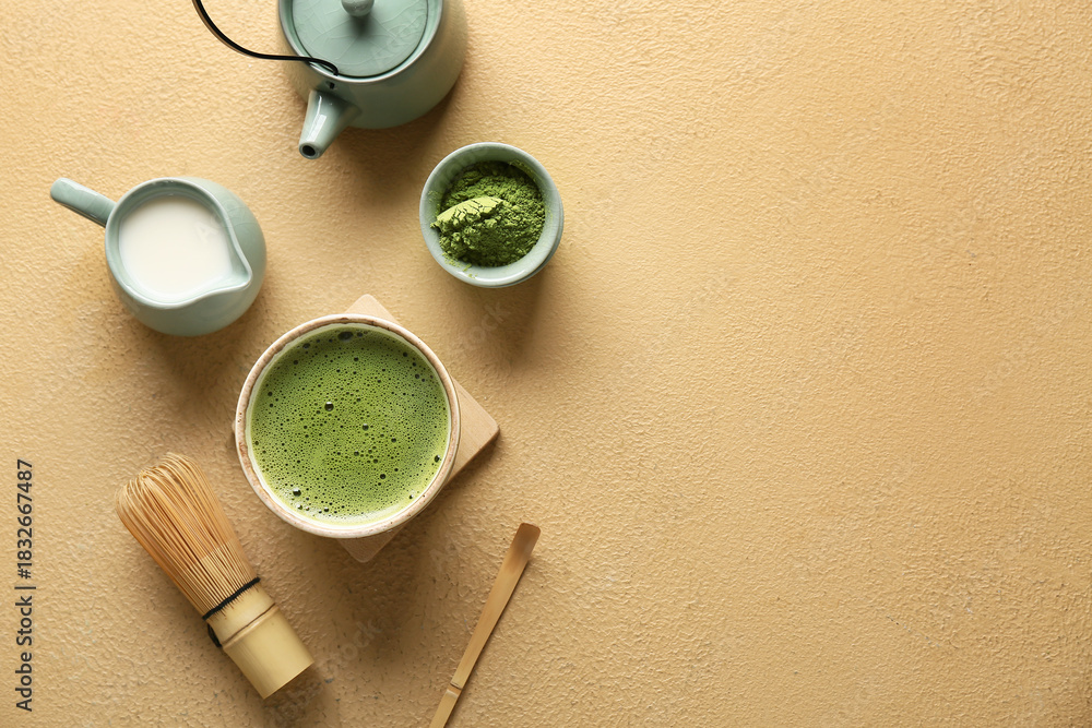 Fototapeta premium Composition with bowl of tasty matcha tea, chasen and teapot on beige grunge background