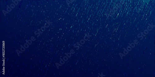 Abstract dark blue background with scattered light spots and streaks