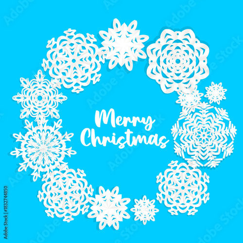 Beautiful circle frame from white Christmas applique snowflakes of different shapes on blue background