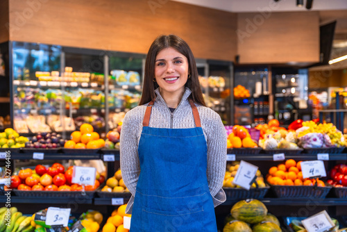 Woman working in supermarket grocer department smiling portrait