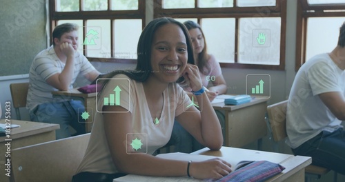 Smiling teen wearing light pink top, leaning on left hand at front desk with notebook, HUD