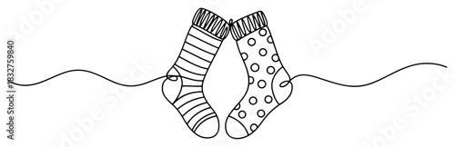 Continuous one line drawing of cute hanging socks pair with stripes and dots patterns for laundry or winter design