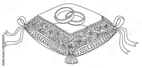 Two wedding rings on a decorative pillow vector illustration black and white outline drawing of gold bands on a floral cushion for marriage ceremony