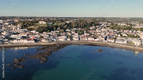 Wallpaper Mural Guernsey.Belle Greve Bay circling high drone footage along the sea front from the Longstore turning south looking over the QEII Marina and St Peter Port Harbour with calm clear water on sunny day Torontodigital.ca