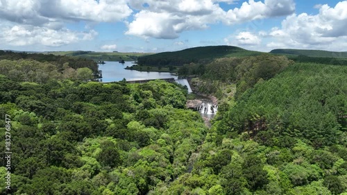 Aerial drone view of Divisa Dam in São Francisco de Paula, Brazil. Lush forest and calm reservoir waters. Ideal for nature, travel or environmental projects.
