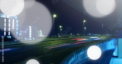 Long-exposure trails starting as highway streaking and bokeh discs growing, showing traffic flow